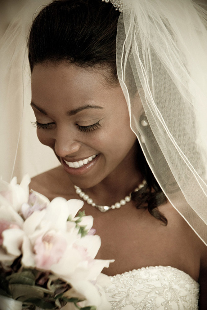 pretty bride is smelling the flowers