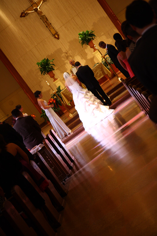 bride and groom in a church during the ceremony holding hands catholic mexican wedding
