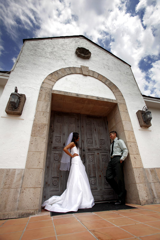 bride and groom next to Church in Houston, TX