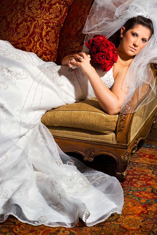 bridal portrait bride laying down red roses
