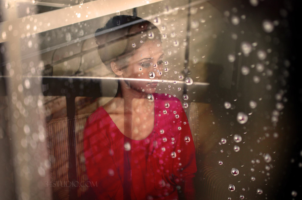 indian bride getting ready while raining water drops on the window