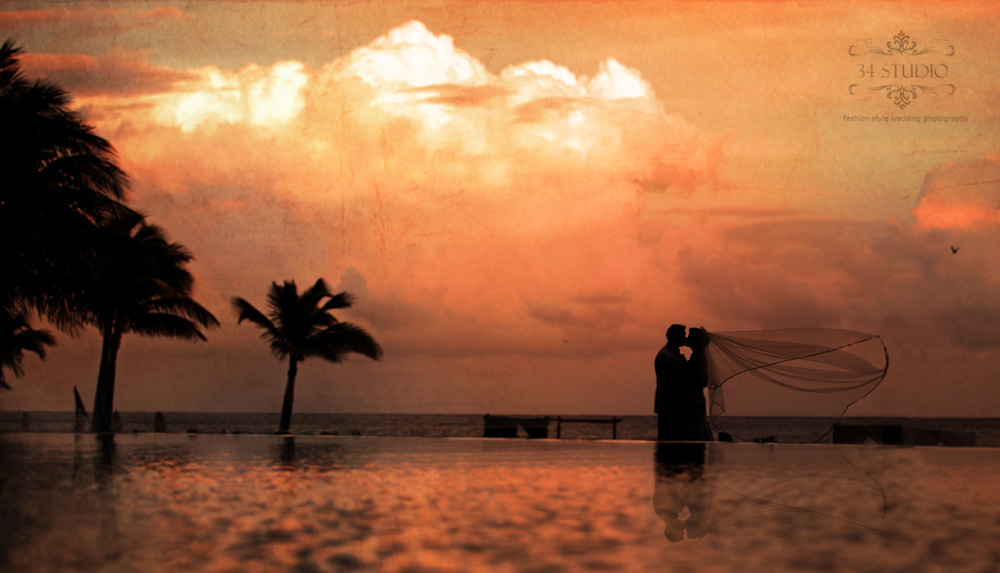 bride and groom by infiniti pool in playa del carmen mexico 