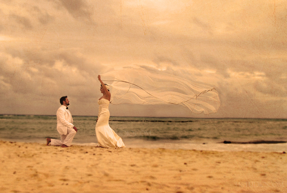 bride and groom grand velas mexico flying veil on the beach