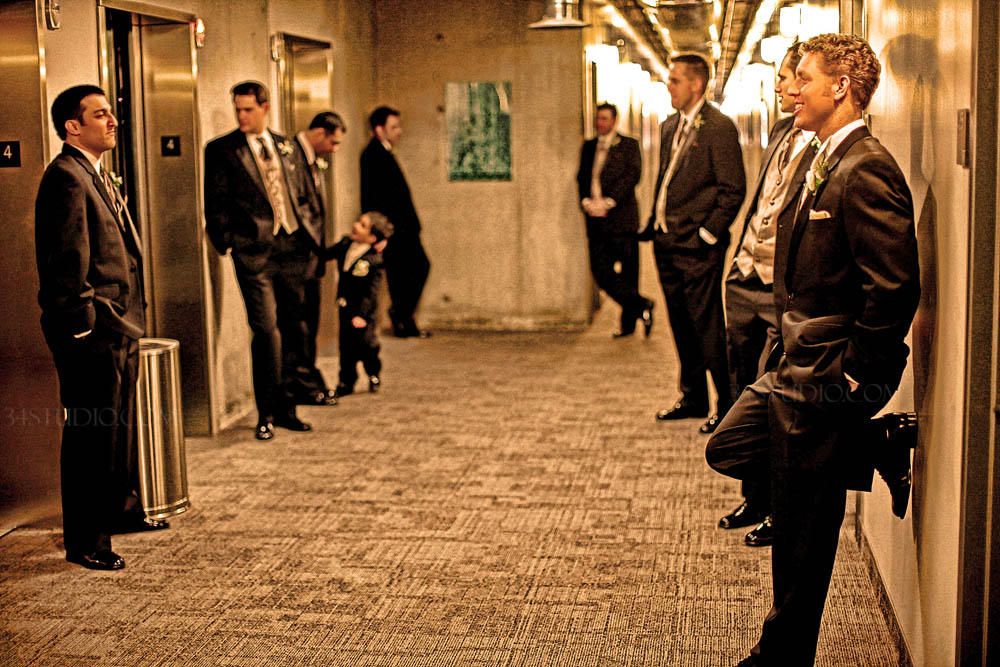 groomsmen lined up waiting for elevator at Nylo Hotel Irving Texas
