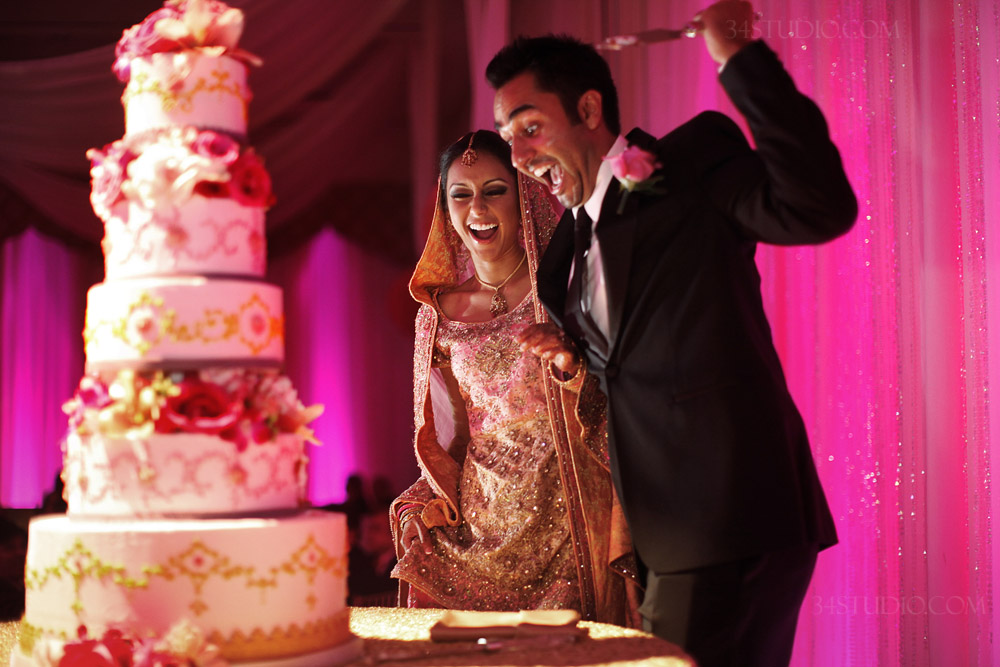 indian couple cutting the wedding cake at four season irving texas